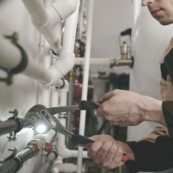 Photo of plumber working. Betros Plumbing offers commercial plumbing services.