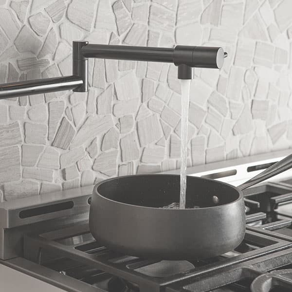 Photo a pot filler on a stove. Betros Plumbing offers kitchen plumbing remodel services.